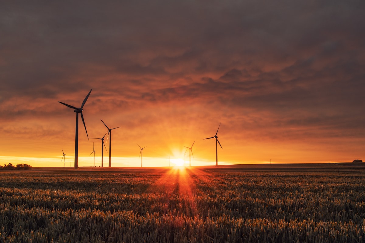 White wind turbines on green hills in northern Spain